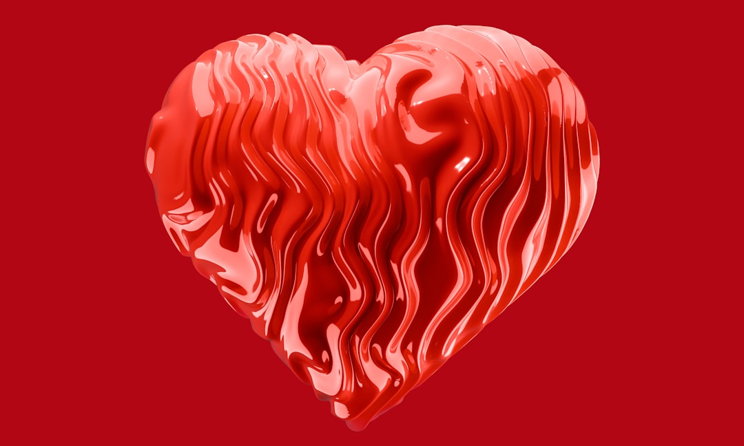 A red heart shaped object on a red background
